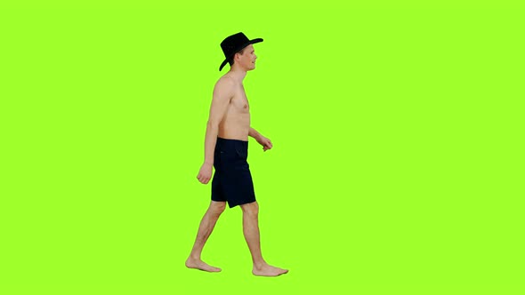 Topless Young Man Walking in Black Cowboy Hat 