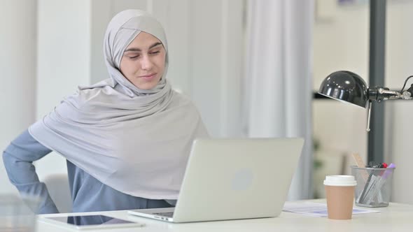 Young Arab Woman with Laptop Having Back Pain alt