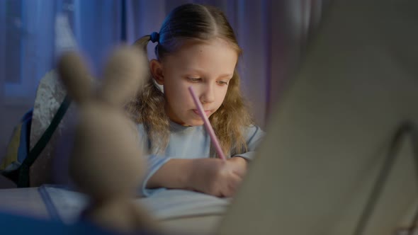 Schoolgirl Junior School Does Homework In The Evening alt