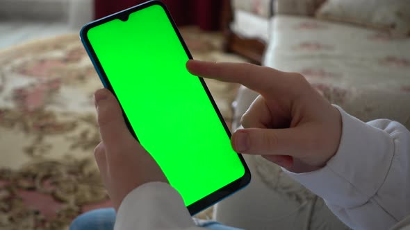 A teenager looks at information on a smartphone alt