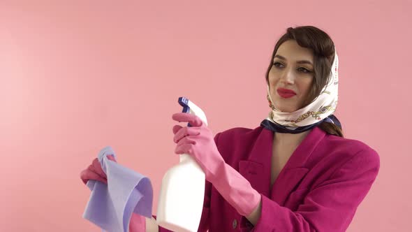 A Woman with a Spray in Her Hands Washes an Invisible Window with Gloves