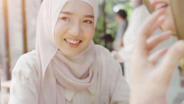 Young Asian Muslim Women Enjoying A Relaxing Moment in the Coffeeshop 01 alt