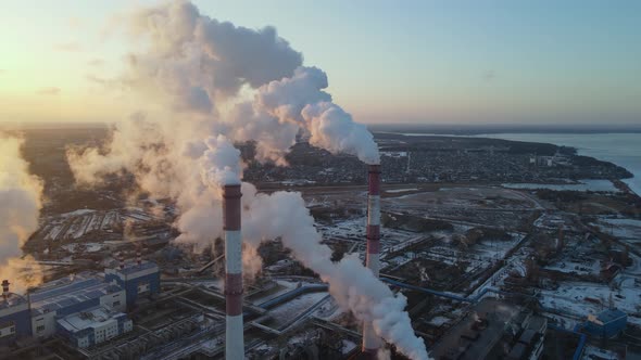 Plant pipes pollute atmosphere. Industrial factory air pollution alt