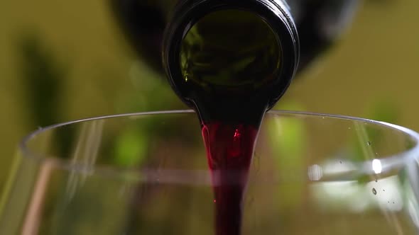 Pouring red wine from a bottle
