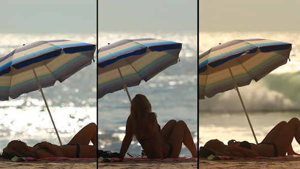 Hot Woman Relaxing at the Beach Under a Parasol