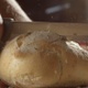 Man Cutting A Piece Of Bread With A Knife In The Kitchen On A Sunny Day Shot On Red Camera - VideoHive Item for Sale