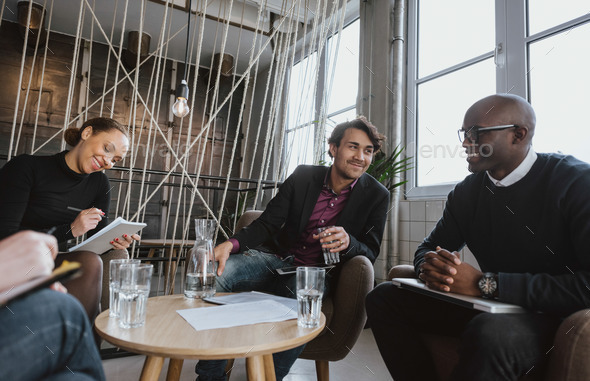 Executives having a meeting indoors - Stock Photo - Images