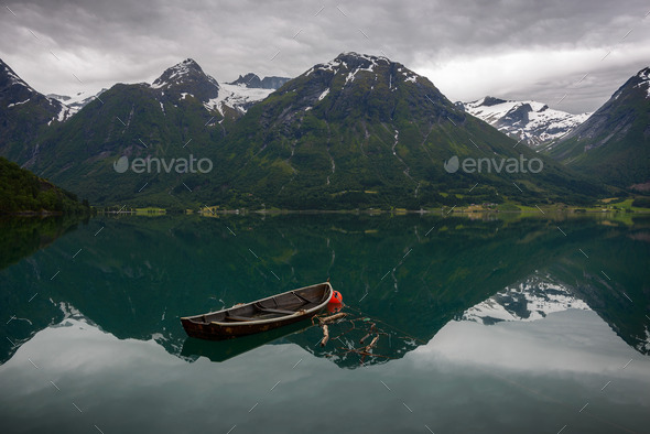 An old boat and some mountains - Stock Photo - Images