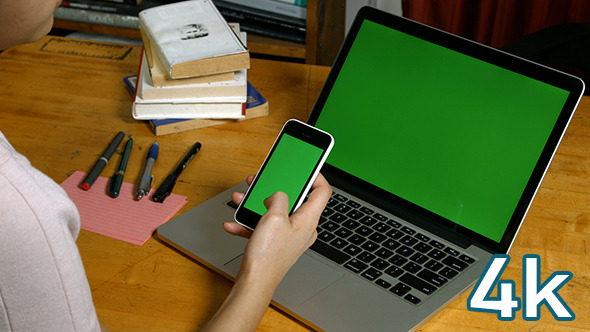Girl Using Smartphone With Laptop Green Screen