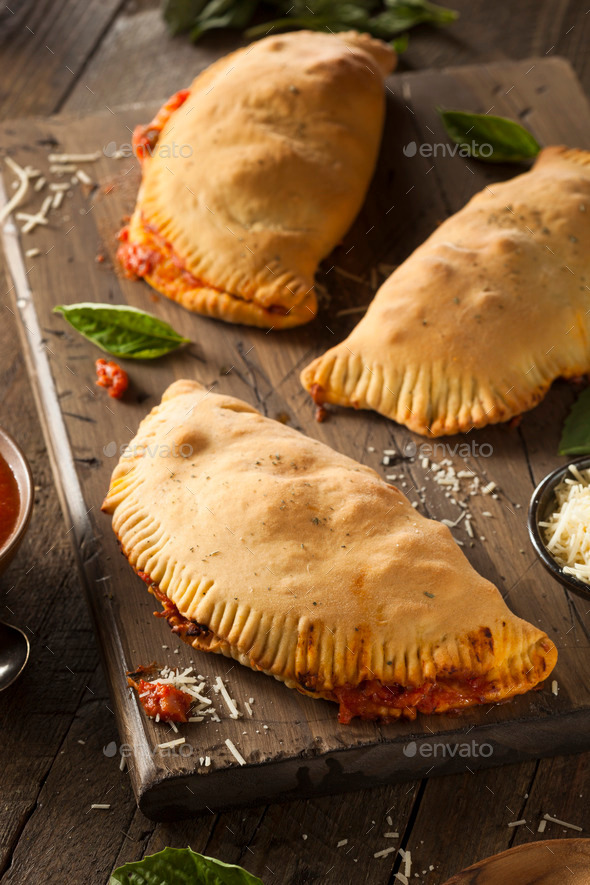 Homemade Italian Meat and Cheese Calzones Stock Photo by bhofack2