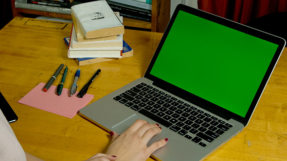 Girl Using Laptop with Green Screen