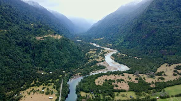 Aerial orbit of the Cochamo Valley on a cloudy day, Chile. Cochamo River. alt