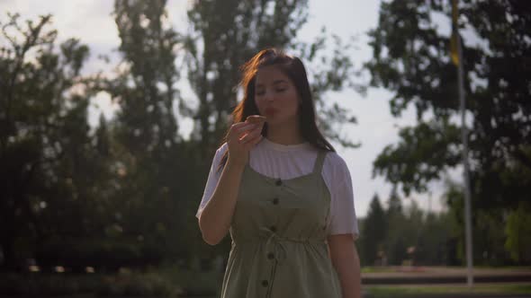 Attractive Happy Woman Eating Ice Cream on Summer Walking