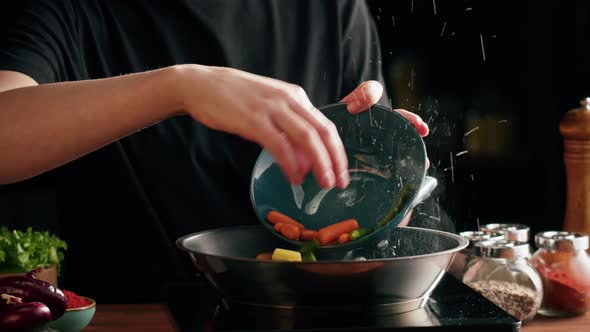 Chef Frying Vegetables in Pan Closeup alt