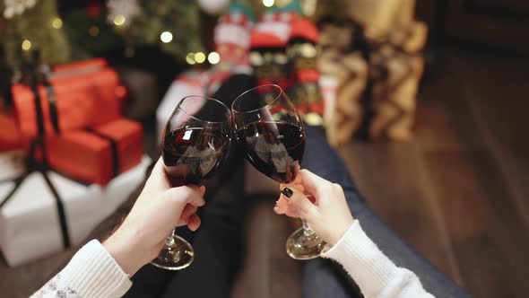 Happy Couple Clink Wine for Christmas and New Year Celebrations