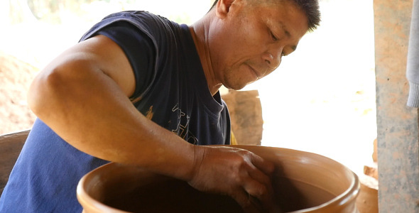 Man Working On Pottery Wheel alt