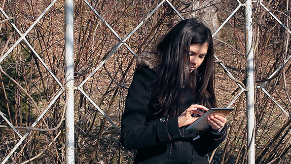Girl with Tablet in the Park alt