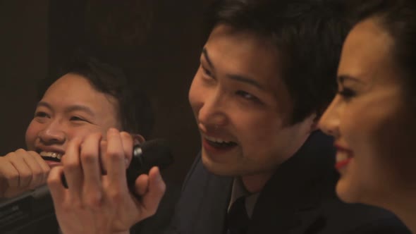 Males and female singing karaoke alt