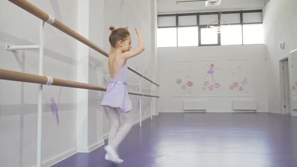 Lovely Little Ballerina Practicing Her Dancing at Ballet School