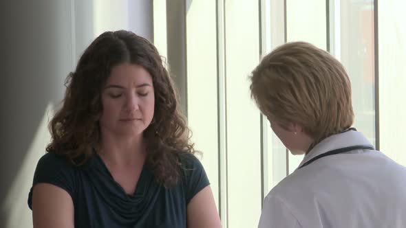 Female Doctor Comes In To Speak To Her Female Patient (5 Of 5)