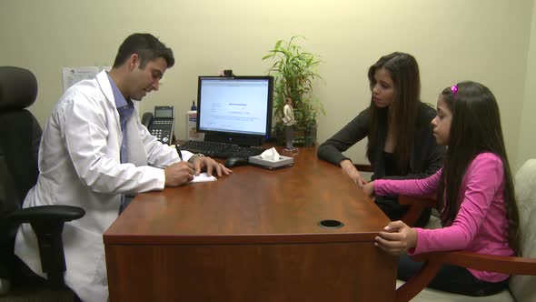 Male Doctor Consults With Mother And Daughter (1 Of 7)