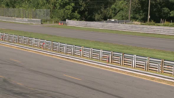 Race Cars Going By Fenced Area (2 Of 2)