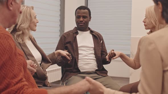 People Holding Hands at Support Group Meeting alt