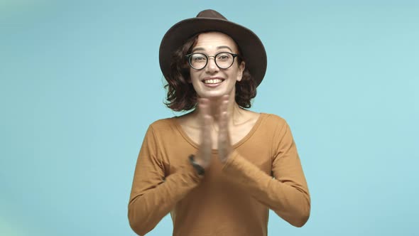 Cheerful Caucasian Woman Supports you Clapping Hands and Smiling Showing Thumbsup in Approval