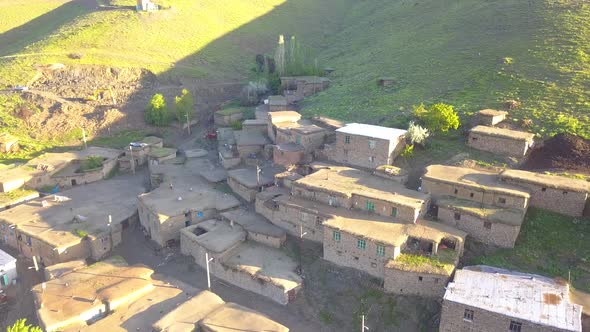 Flight over the rural with birds, A village on a green hill. alt