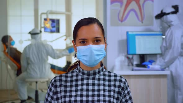 Portrait of Woman with Mask in Dental Office Looking on Camera alt