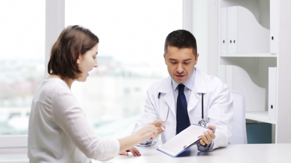 Smiling Doctor And Young Woman Meeting At Hospital alt