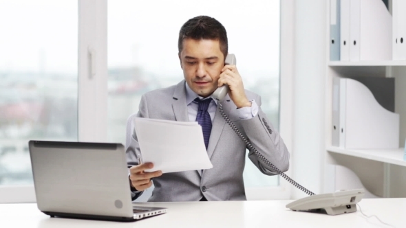 Smiling Businessman With Laptop Calling On Phone, Stock Footage | VideoHive