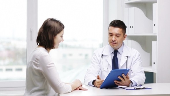 Smiling Doctor And Young Woman Meeting At Hospital alt