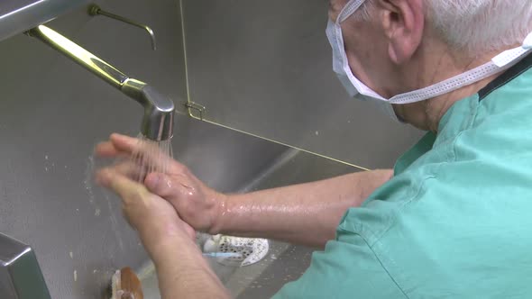 Male Surgeon Scrubbing For Surgery (4 Of 4)