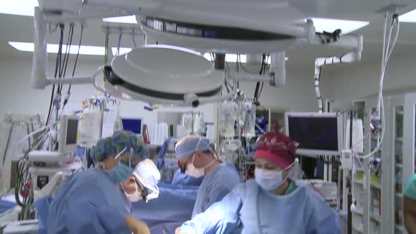 Vertical Pan Of Operating Room And Surgical Team (2 Of 2)
