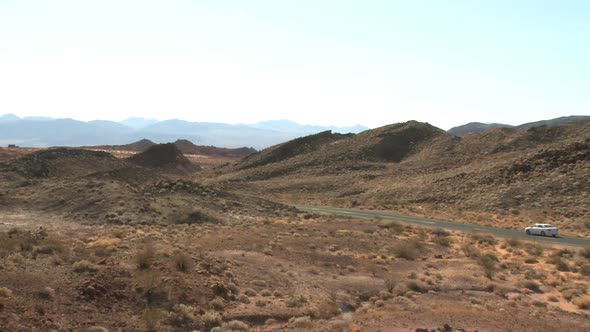 Lone Car Wanders Through Desert