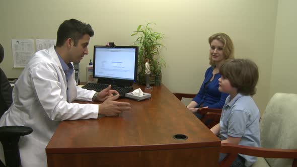 Male Doctor Consults With Mother And Son (1 Of 7)
