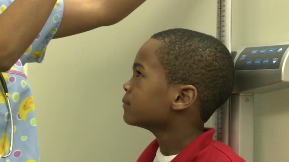 Young Boy Waits To Have His Height Measured