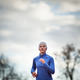 Portrait of a woman running against against blue sky - PhotoDune Item for Sale
