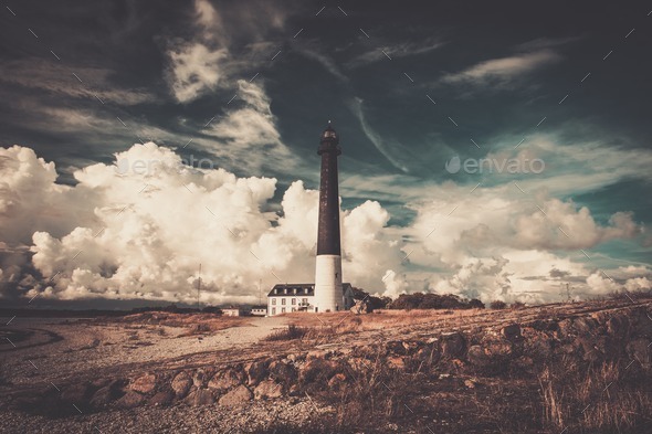 Lighthouse and keeper's house near beautiful bay - Stock Photo - Images