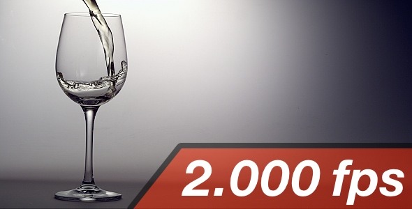 White Wine Is Pouring Into A Wine Glass alt