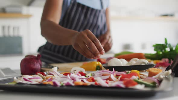 Happy african american woman preparing dinner in kitchen alt