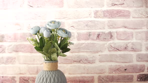 Hand Holding Spray Bottle Watering Plan on Table with Copy Space alt