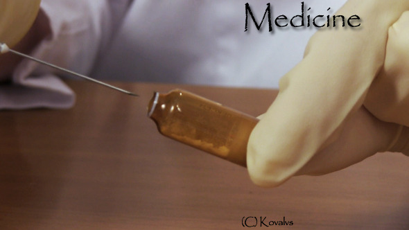 Doctor Gaining Liquid Into Syringe