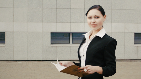 Businesswoman In Black Suit Staying With Notebook