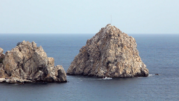 Motorboat in Blue Sea Near Cliffs