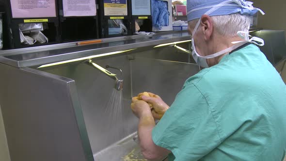 Male Surgeon Scrubbing For Surgery (1 Of 4)