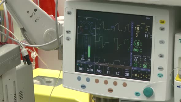 Vitals Monitor With Cell-Saver Machine In Background