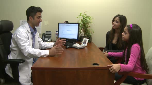Male Doctor Consults With Mother And Daughter (6 Of 7)