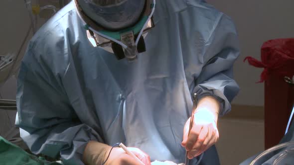 Pan Up Of Doctor Using Electrocautery During Surgery